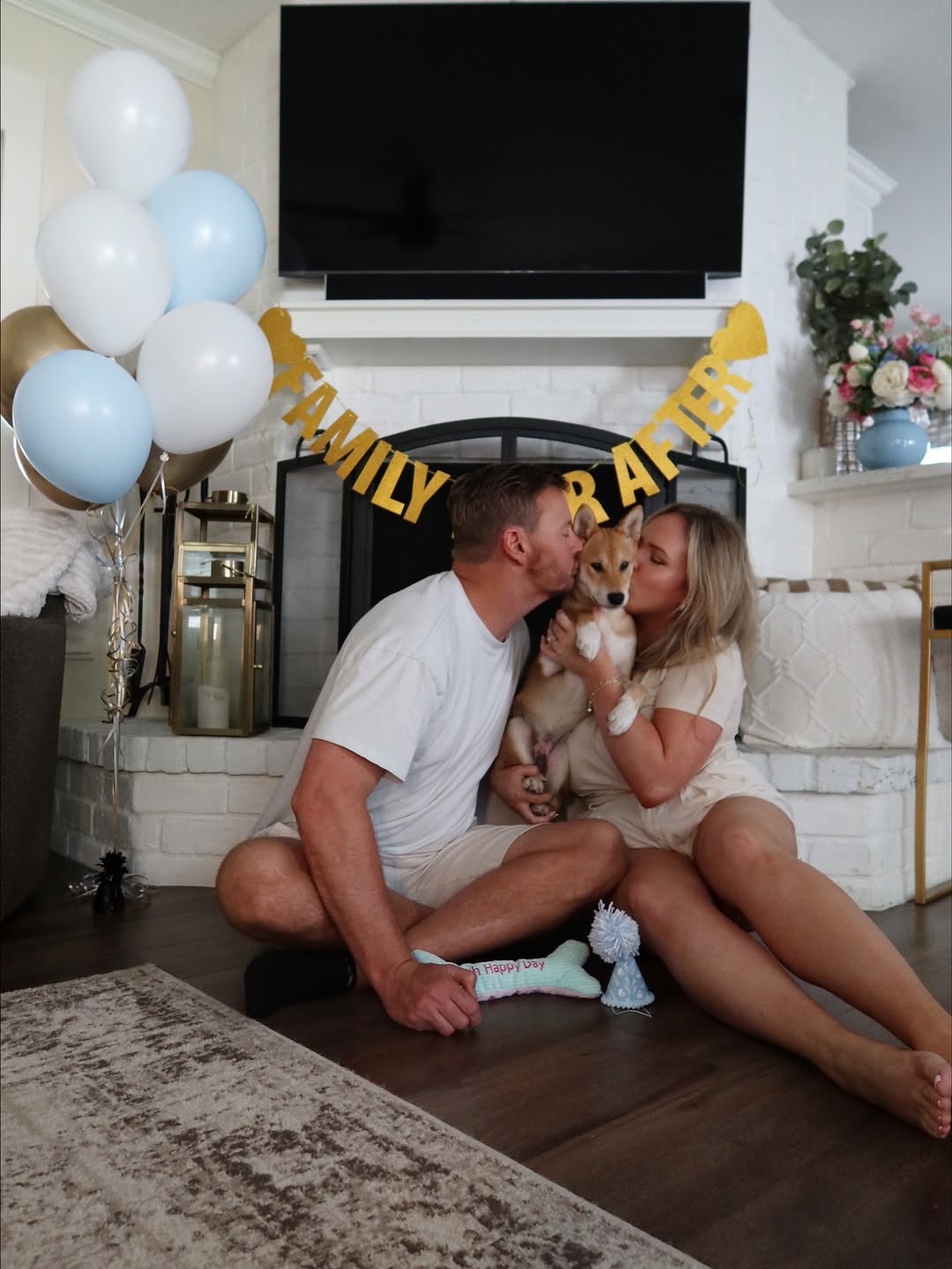 couple kissing a dog