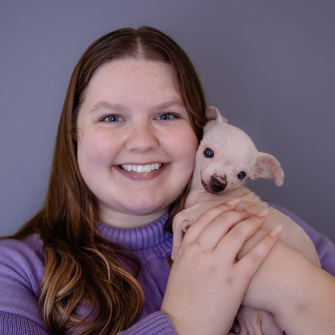 girl holding a dog