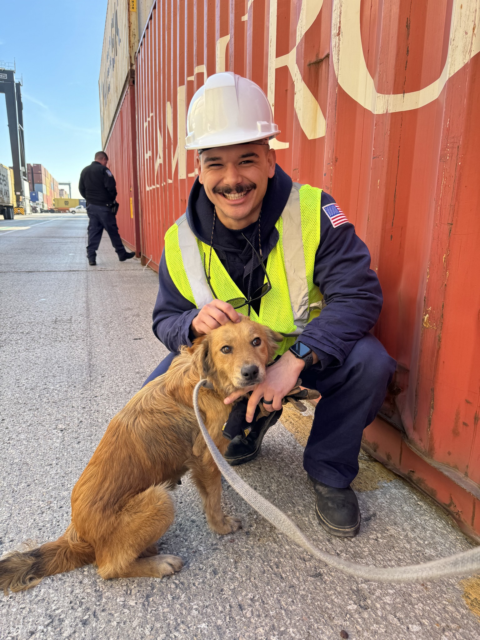man and brown dog on dock