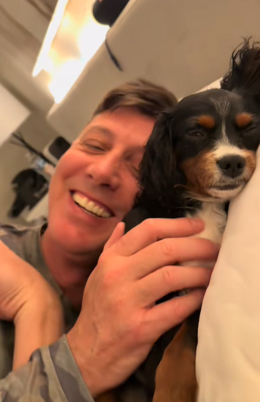 man and dog in bed