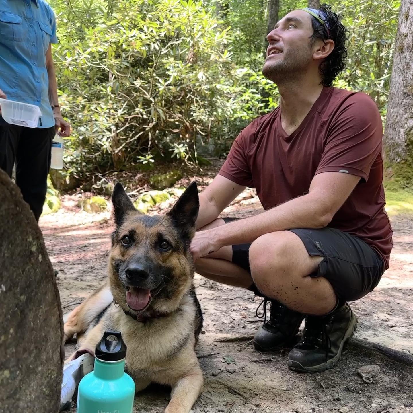 man and dog in forest