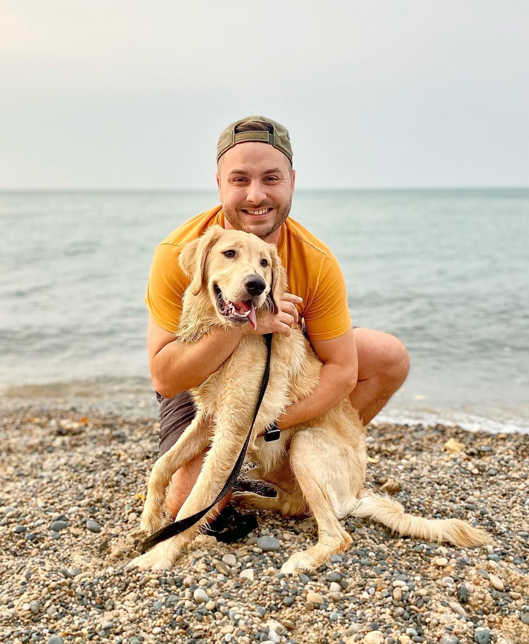 man and dog on beach