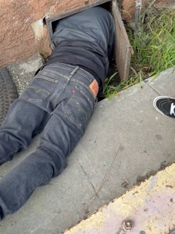 man crawling in tiny space