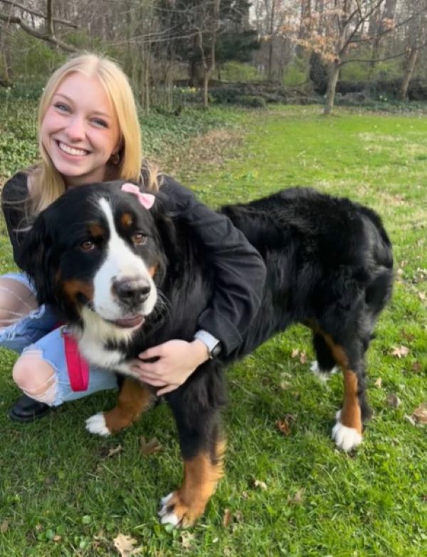 smiling girl with dog in the garden