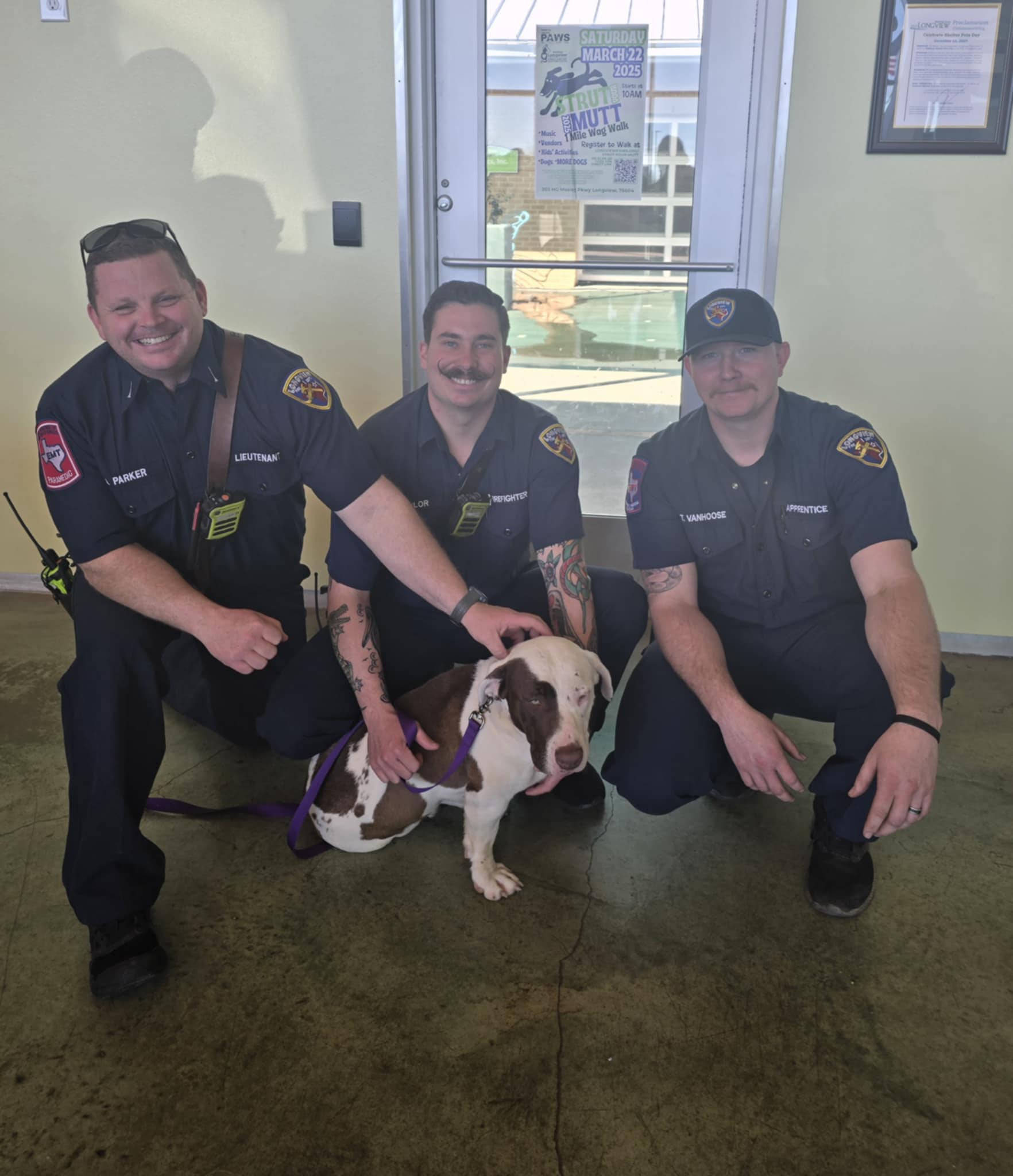three policemen with a dog