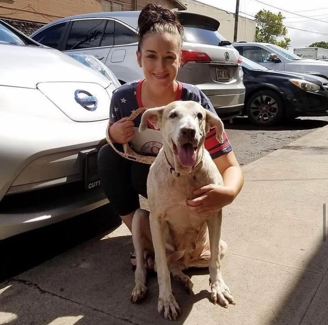 woman and dog on parking lot