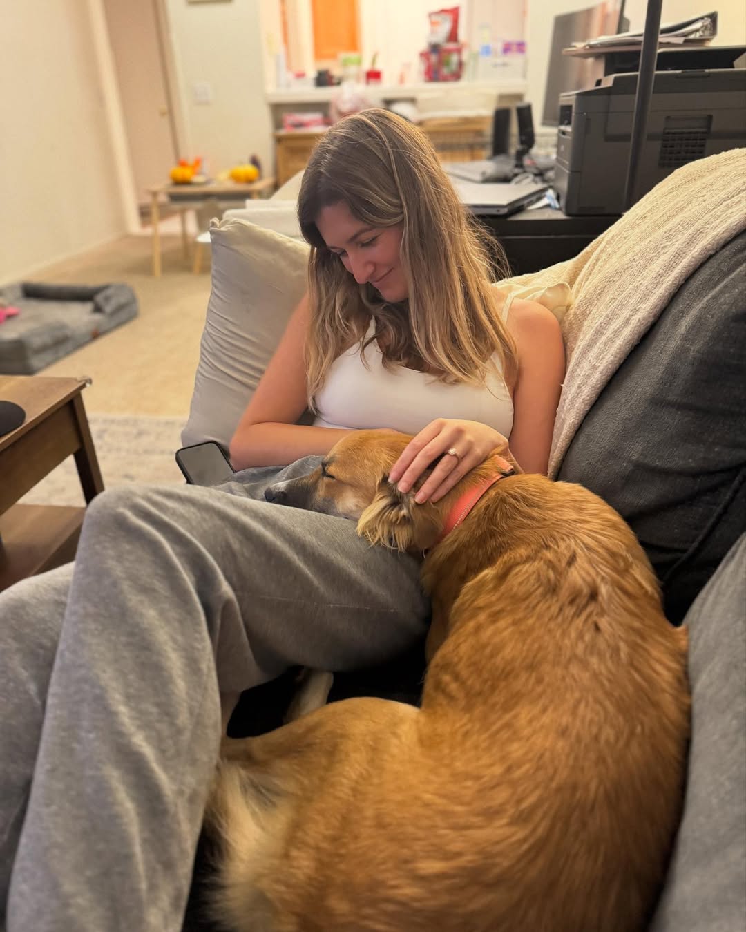 woman and dog sitting on couch