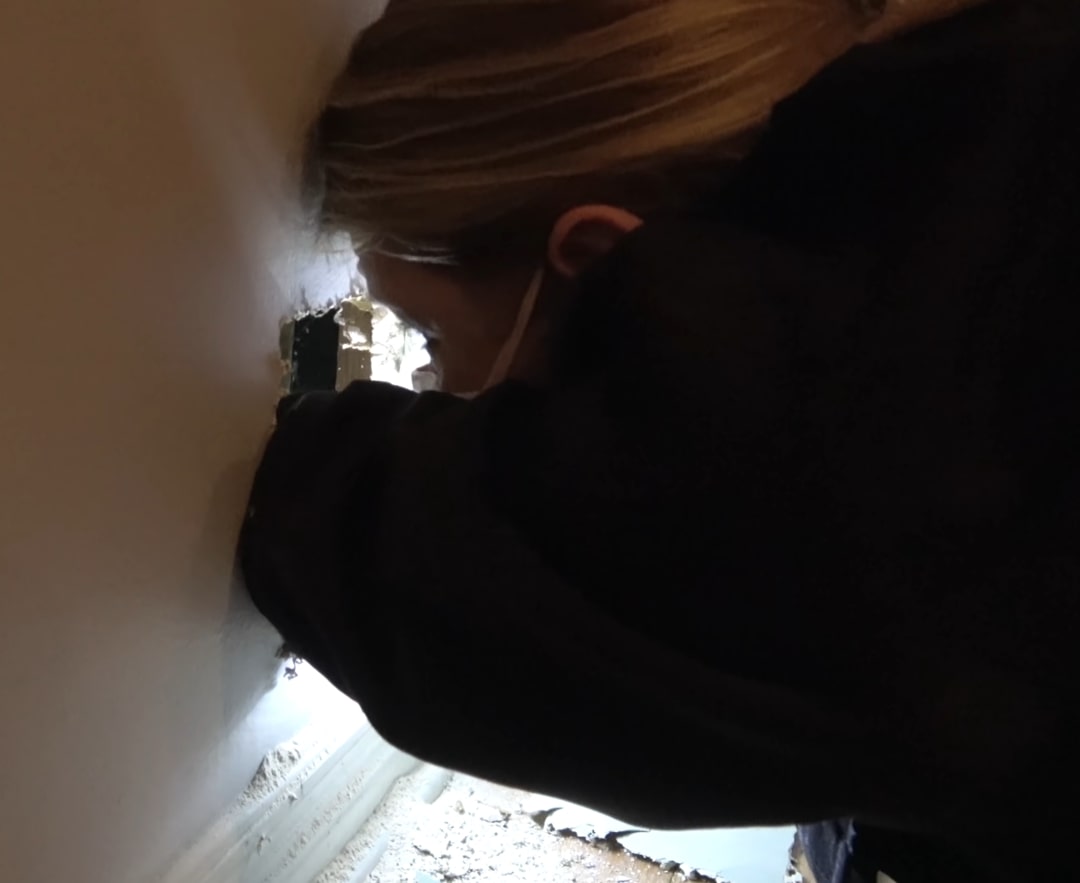 woman checking a wall