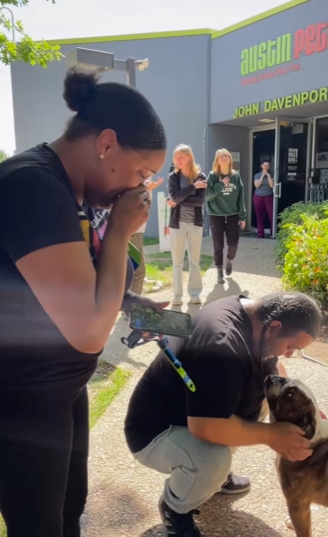 woman crying and looking at dog
