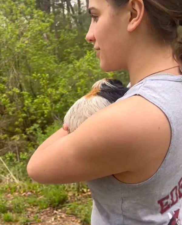 woman holding a stray dog