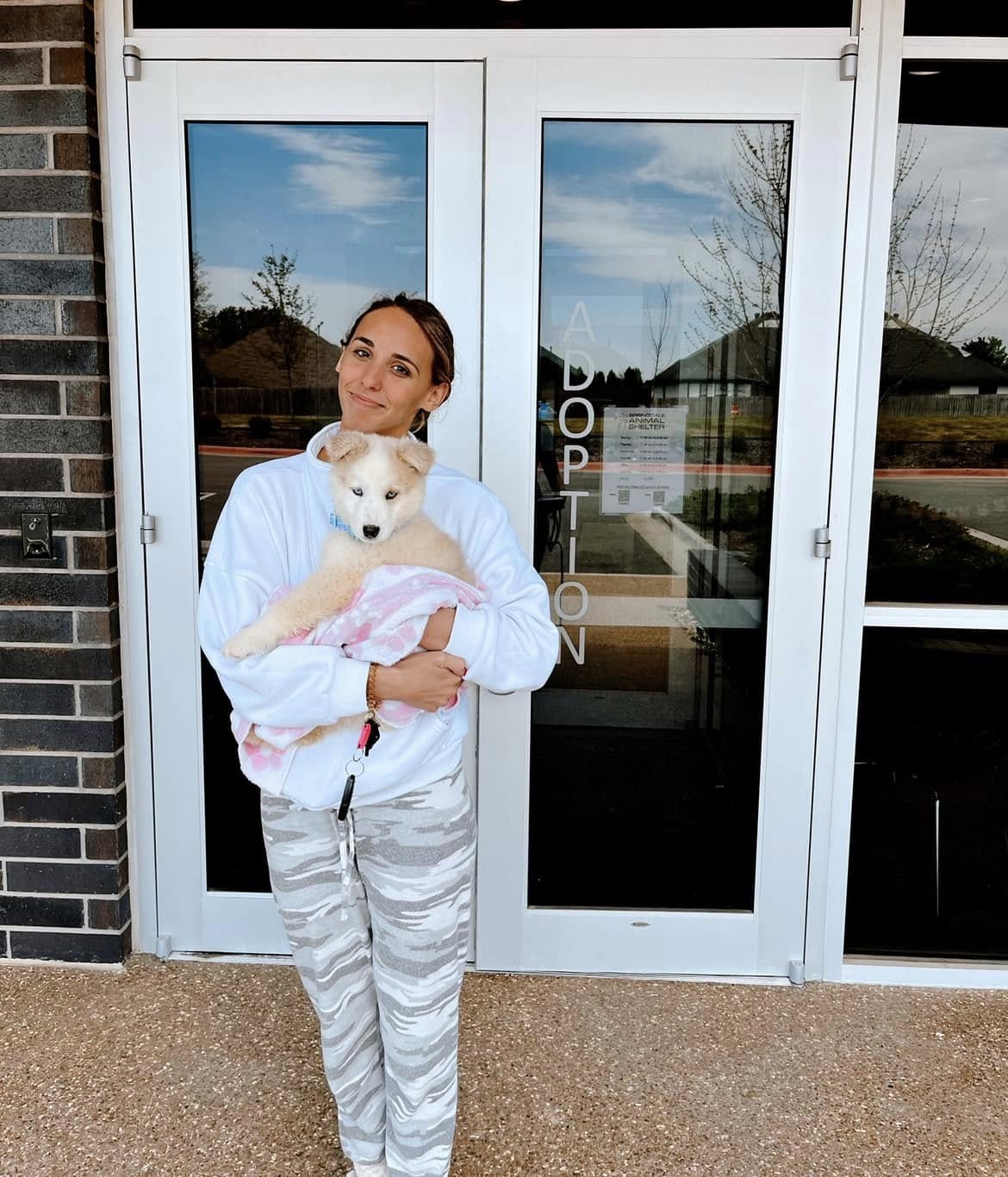 woman holding a very sweet dog