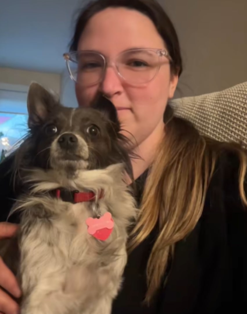 woman kissing a chihuahua