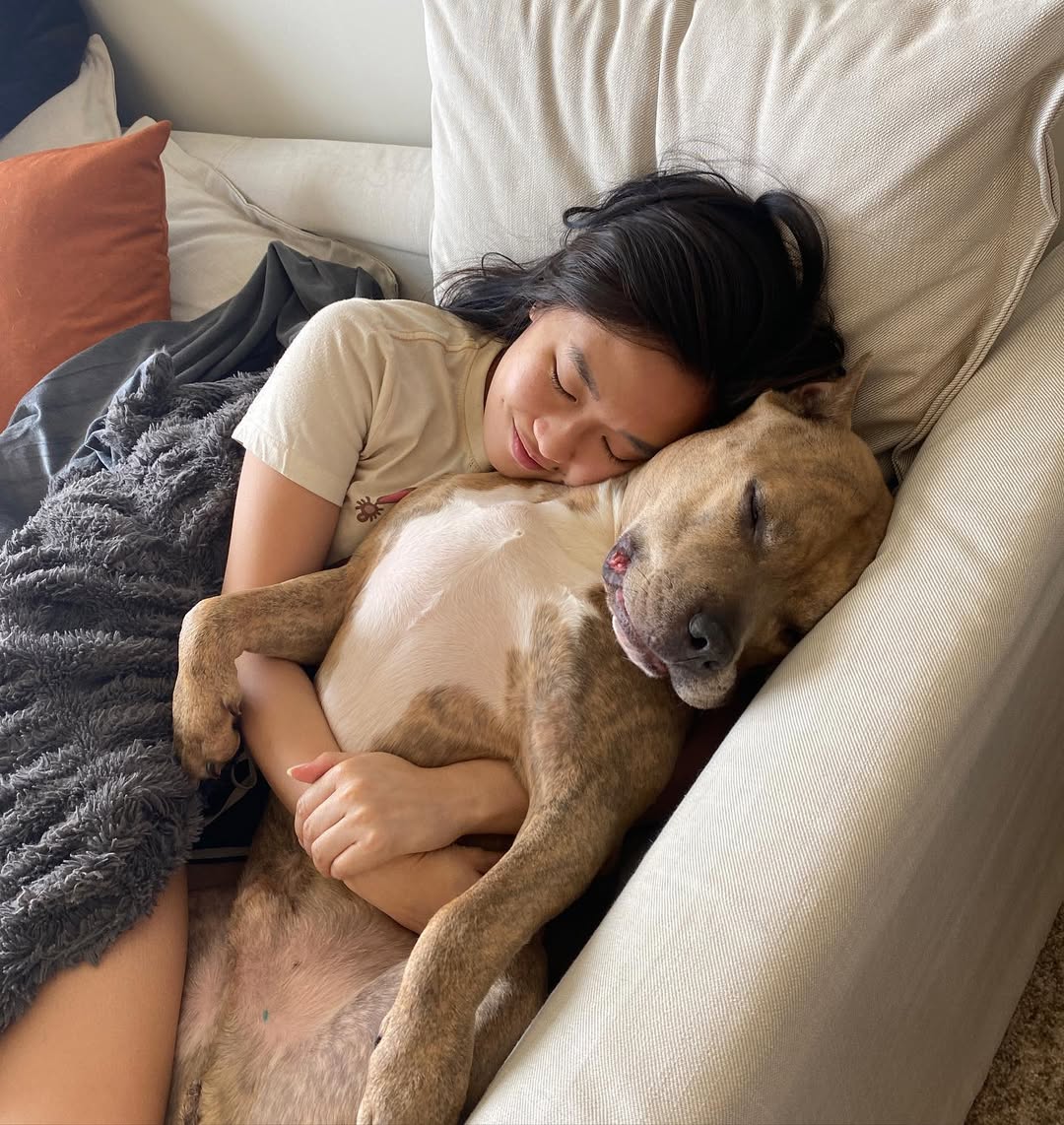 woman sleeping with Pitbull