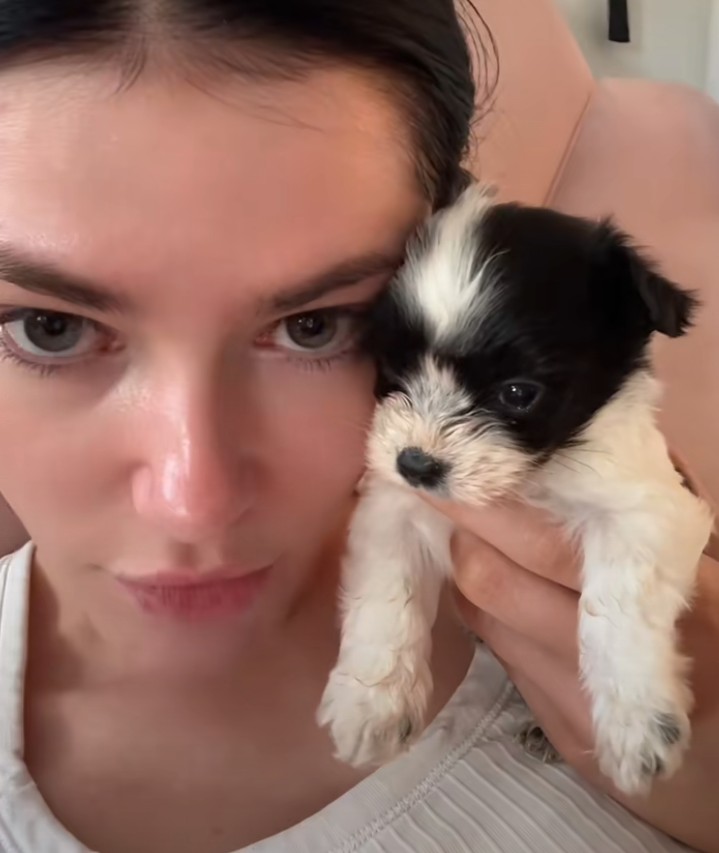 young woman holding a puppy