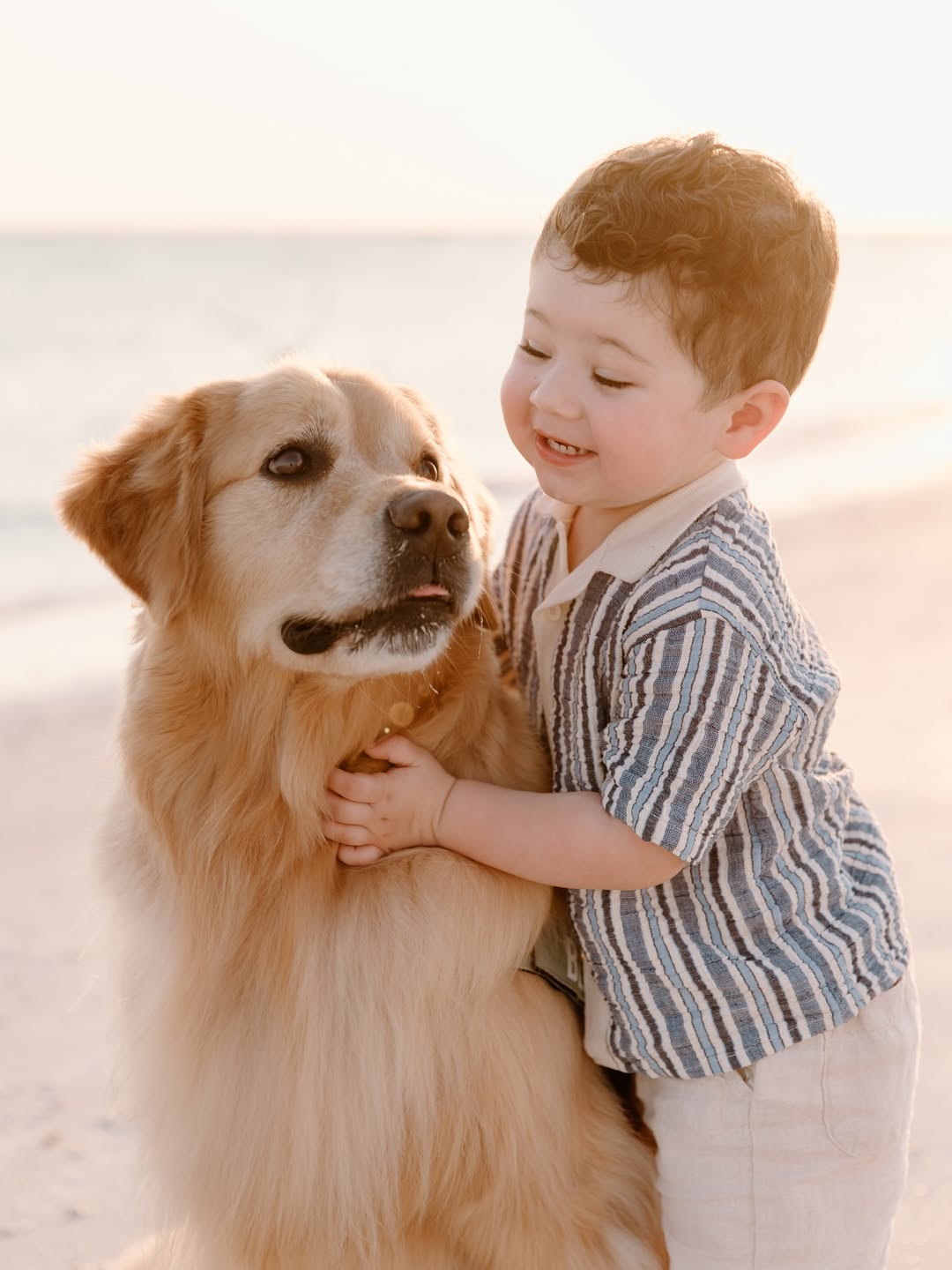 kid and dog on beach