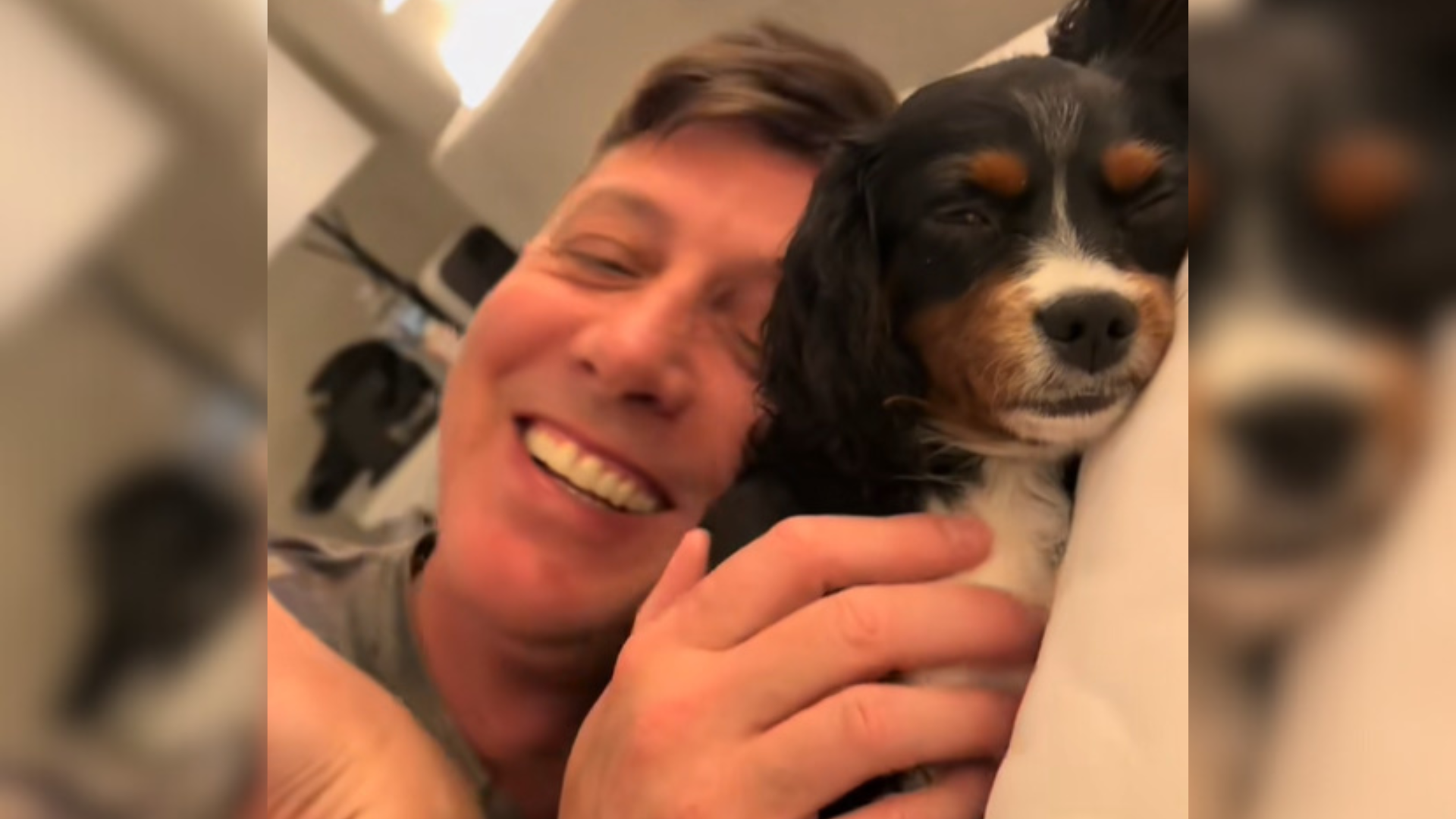 man and dog cuddling