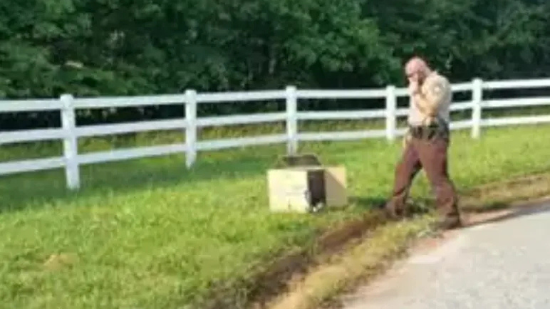 officer with an abandoned box by the road