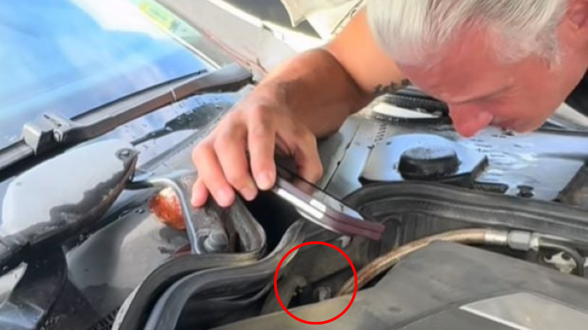 man checking what is inside engine