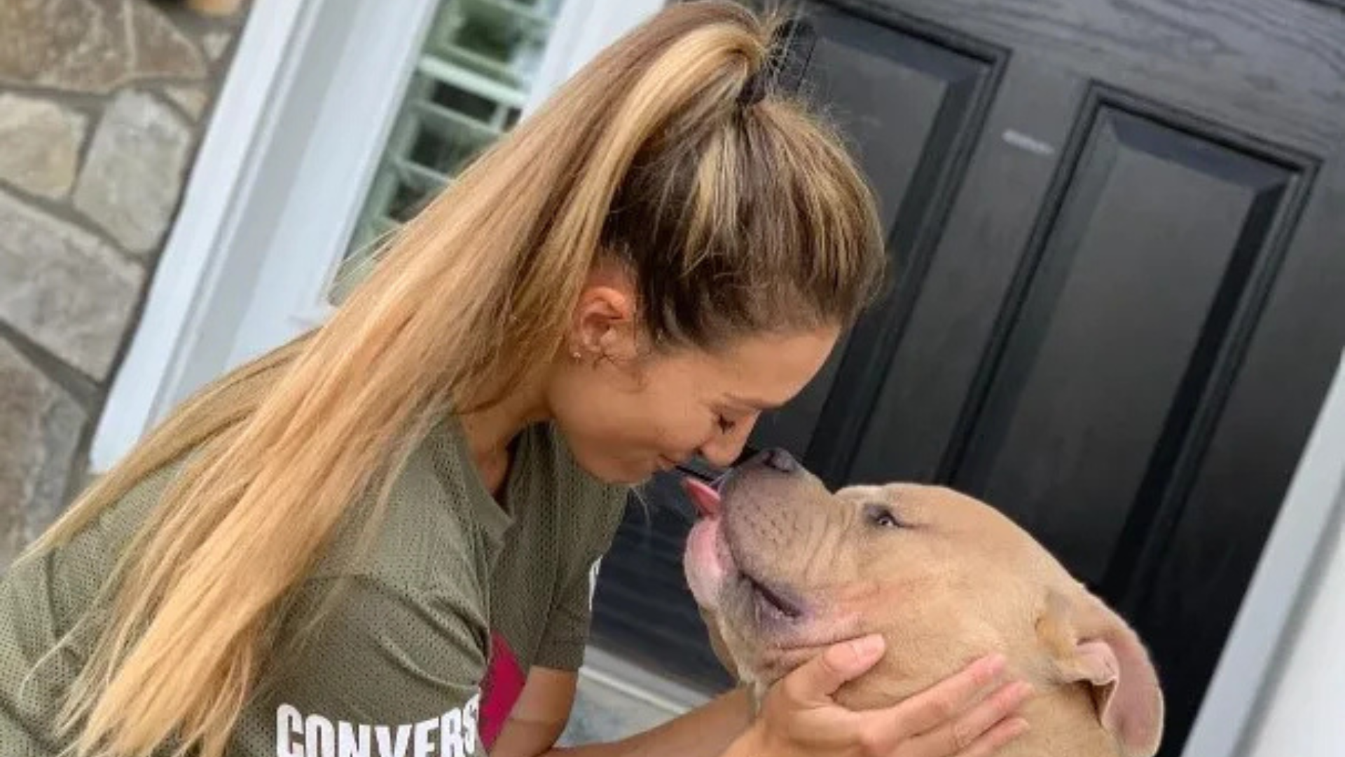 woman and dog hugging