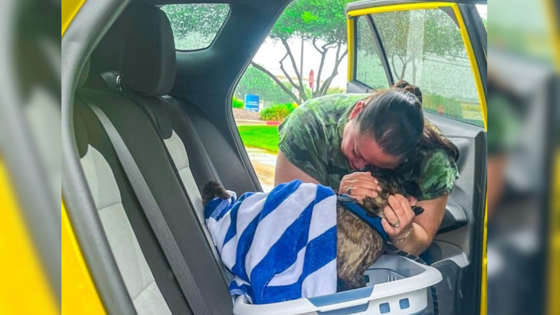 woman hugging dog in car