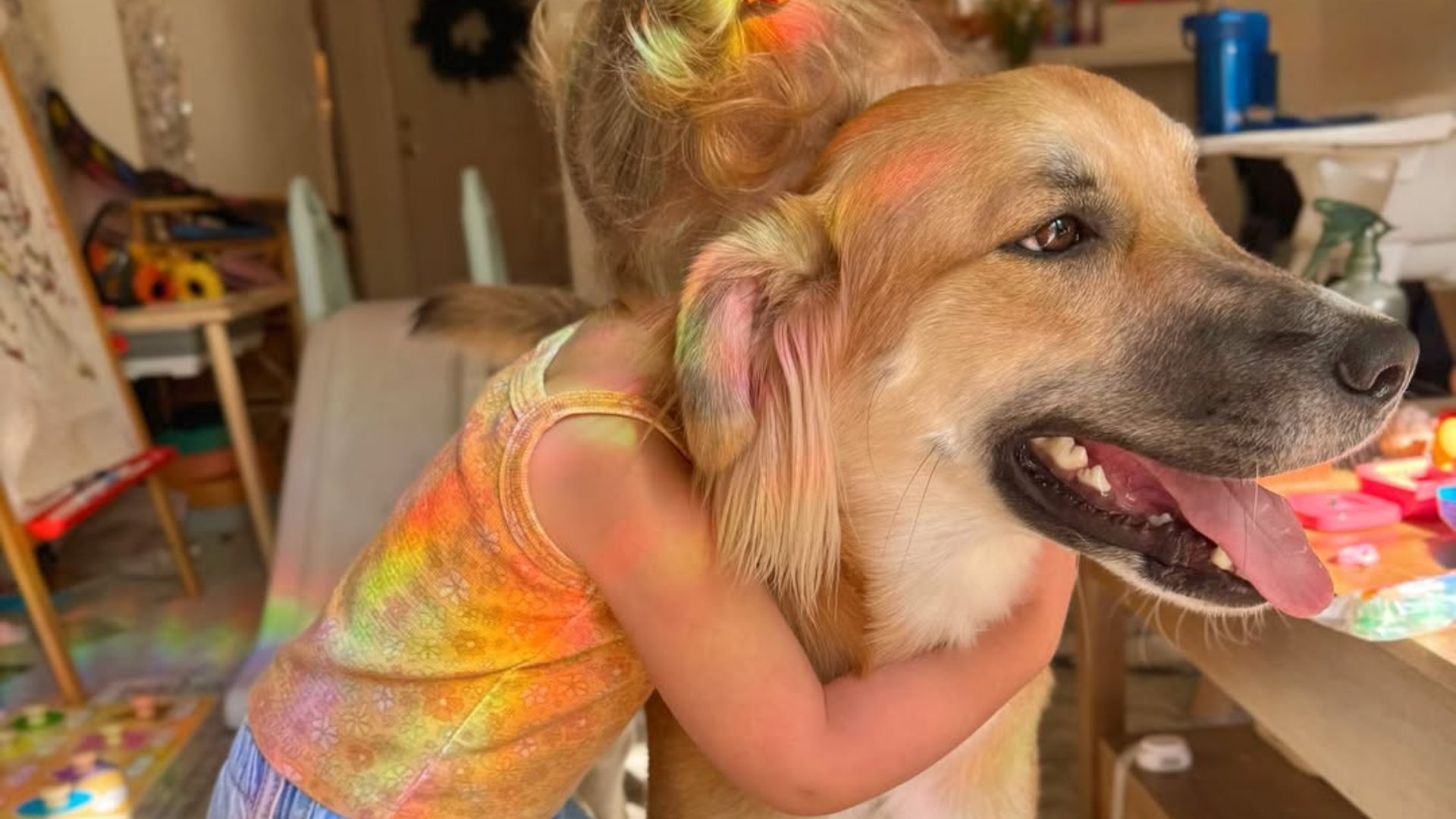 child hugging dog