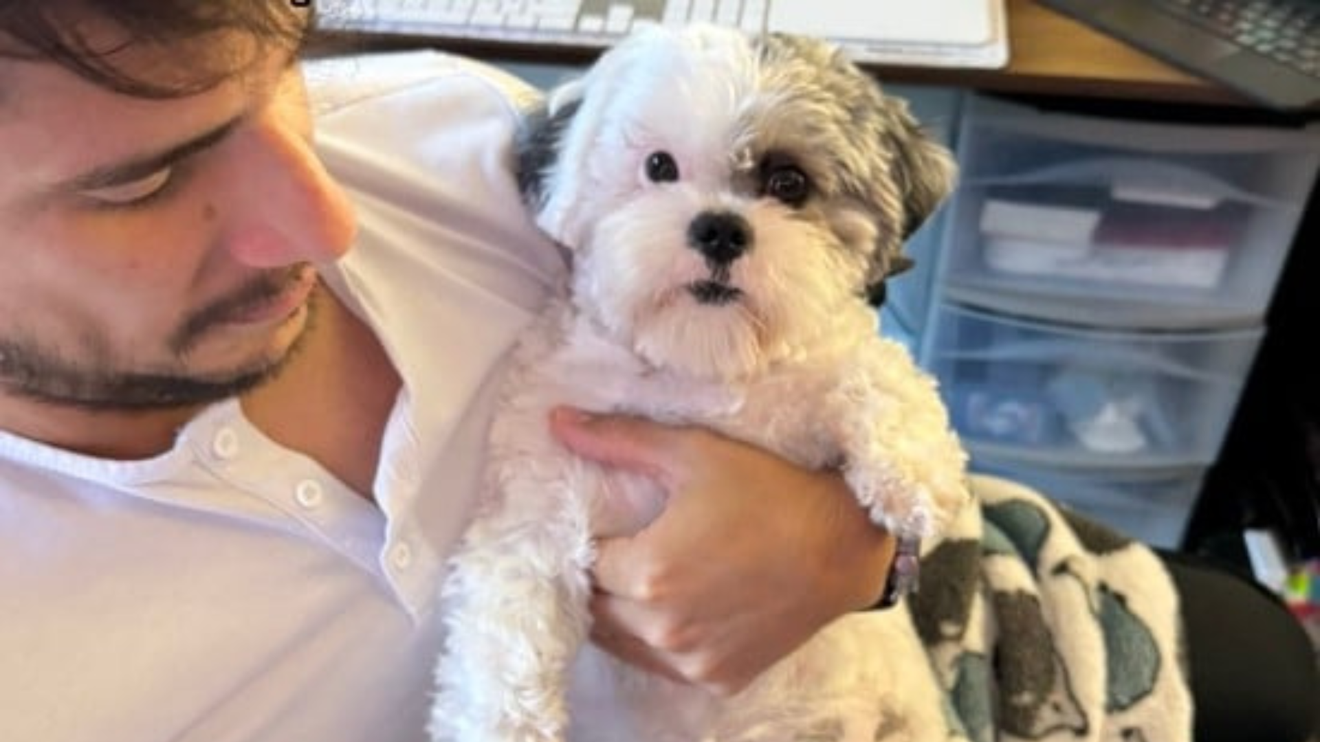 man holding fluffy dog