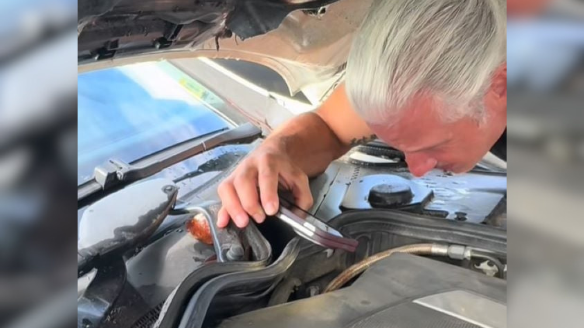 man looking inside engine