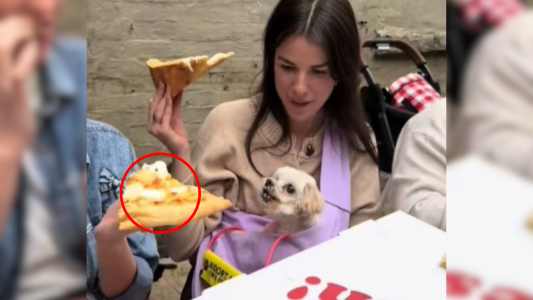 woman with dog eating pizza