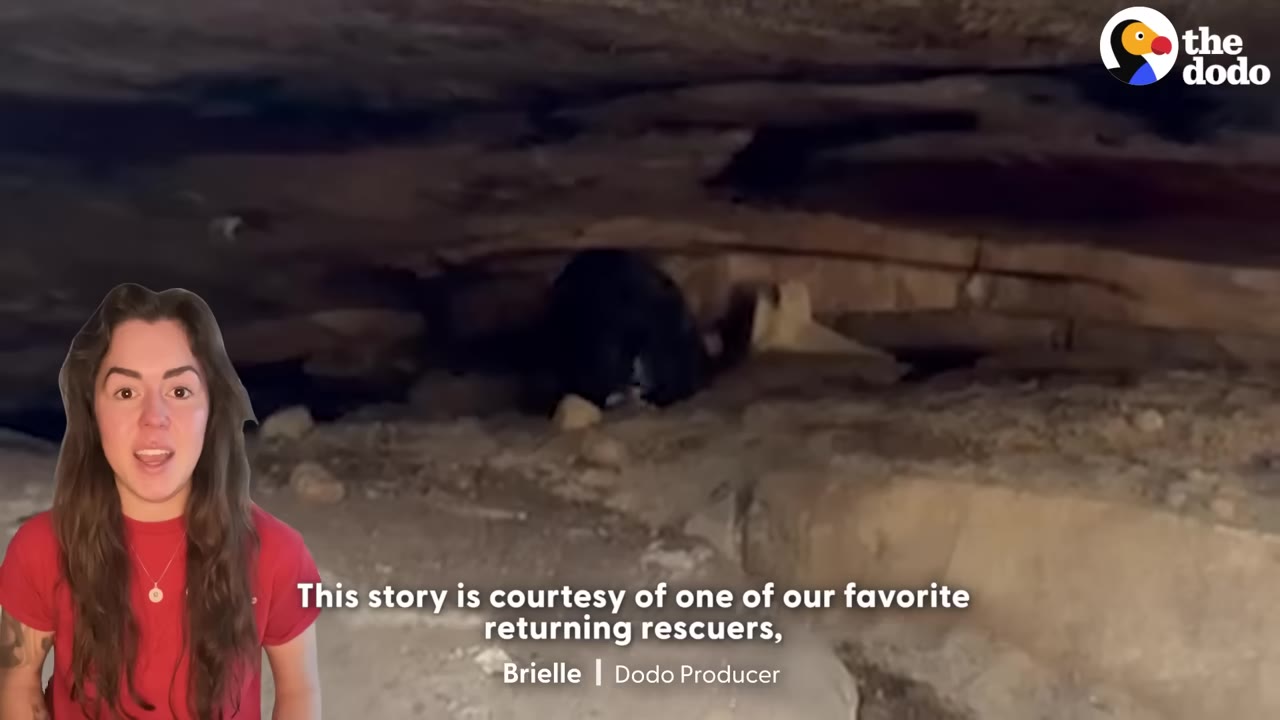 A dark, narrow cave-like opening under layers of rock and dirt, with a presenter in a red shirt superimposed on the bottom left.
