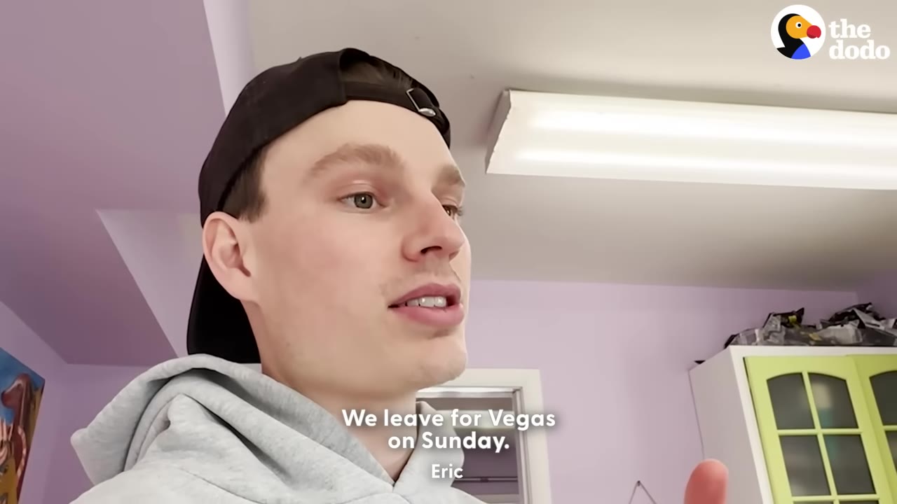 A close-up of a young man named Eric wearing a black baseball cap backwards and a grey hoodie, speaking with a subtitle that reads, 'We leave for Vegas on Sunday.'