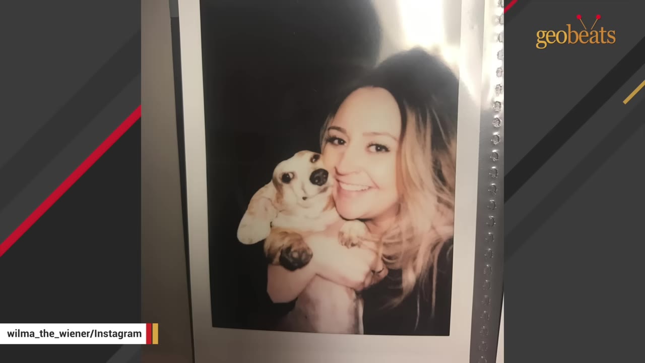 A polaroid photograph of a smiling woman holding a small dachshund puppy close to her face.